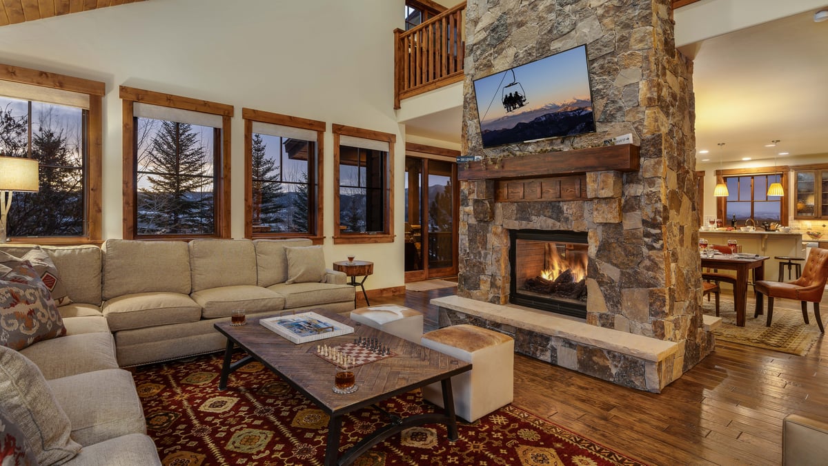 Open great room with cozy couches and fireplace - Image 6