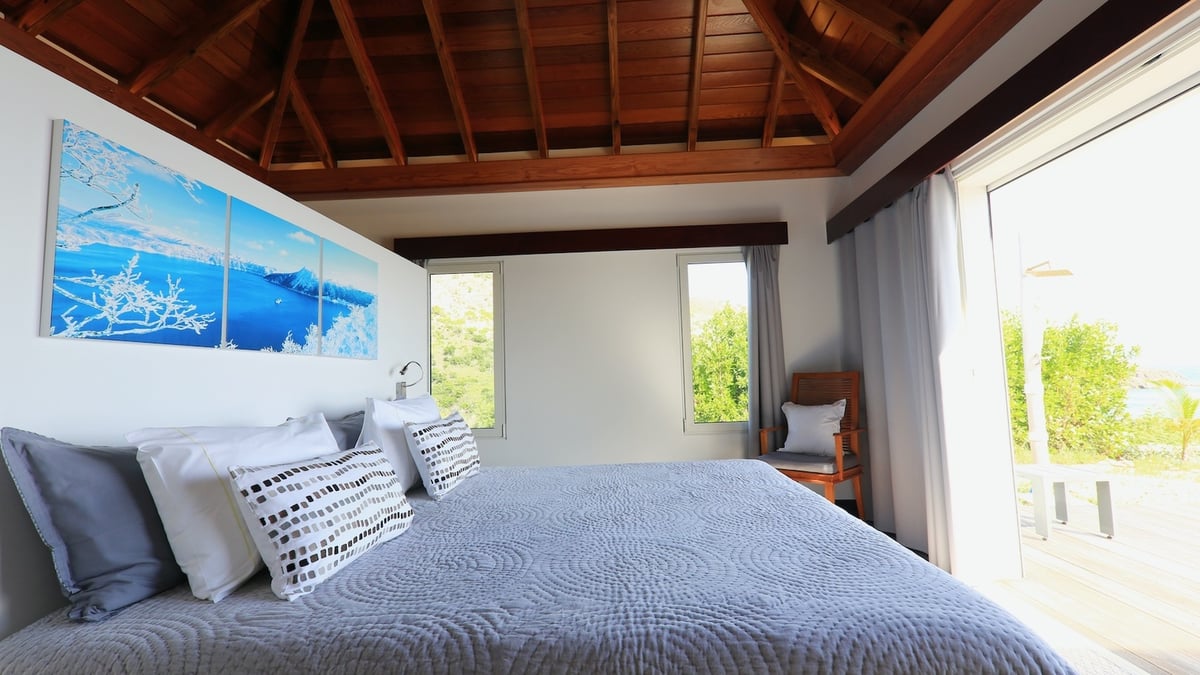 Bedroom 1: Located on one side of the living room. View of the lush tropical environment and the oce - Image 19