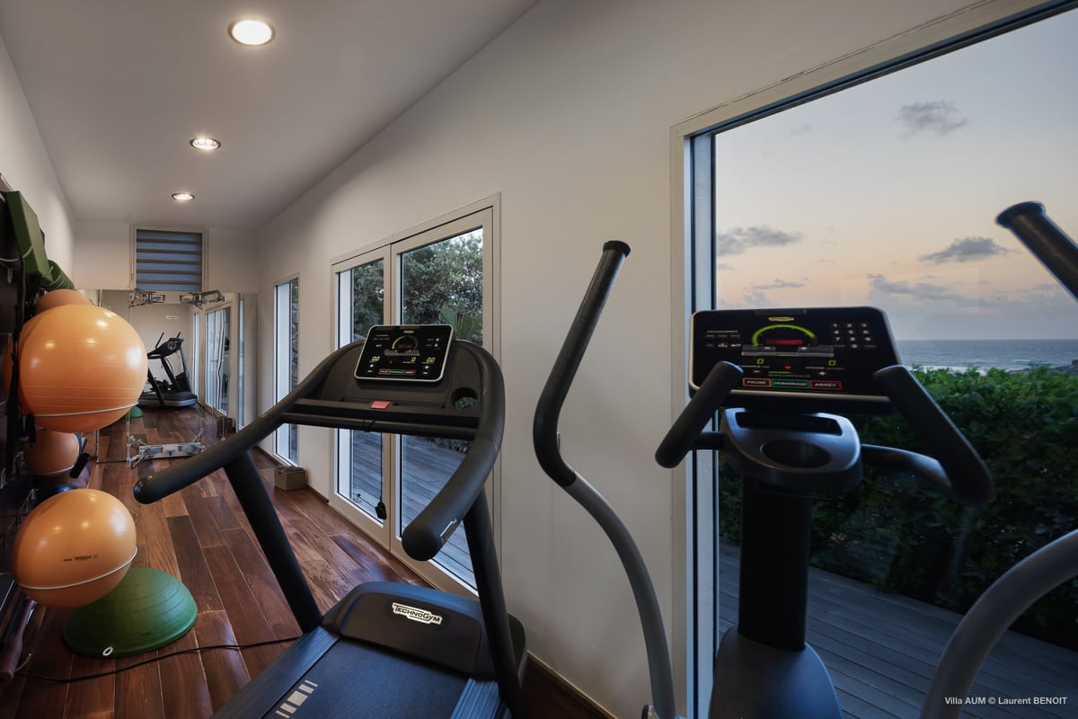 Fitness Room: On the lower level. Air-conditioned fitness room features a treadmill, an elliptic, so - Image 51