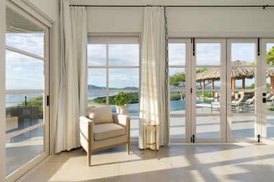 - Watch the waves roll in from this serene indoor perch wrapped in sunlight
- Tall windows frame swe