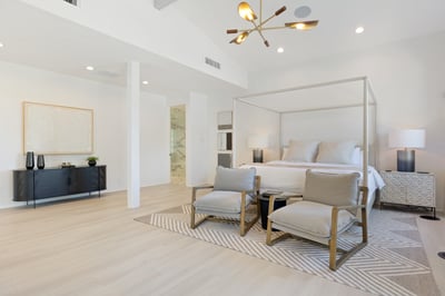 Primary ensuite with a King-sized bed, walk-in closet, and seating area.