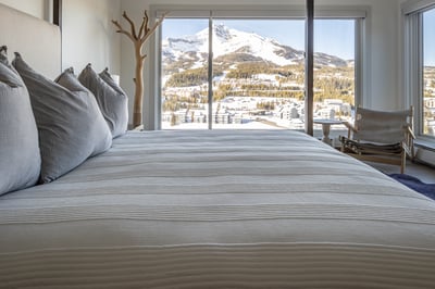 Wake up to breathtaking mountain views from your cozy bed, where snow-capped peaks and alpine charm 
