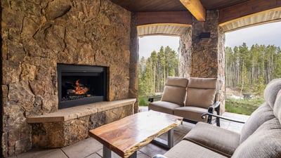 Outdoor living room just outside the rec room with gas fireplace and overhead heaters