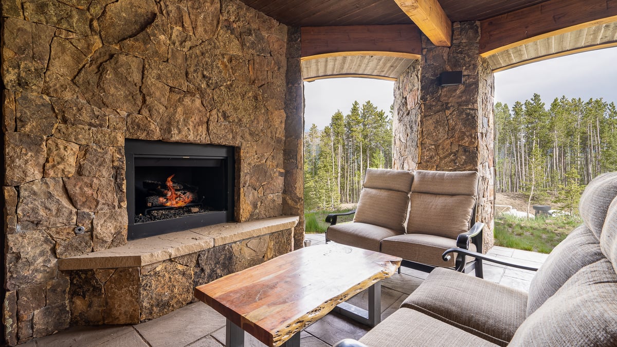 Outdoor living room just outside the rec room with gas fireplace and overhead heaters - Image 10