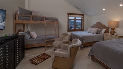 Bedroom with two queen beds and twin bunk beds