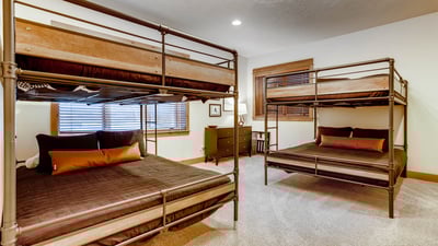 Bunkroom with 2 full over full bunks, adjacent to rec room