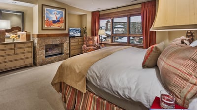 Primary suite with fireplace and TV