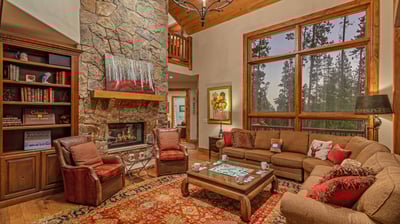 Main level great room with fireplace and deck access