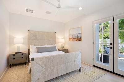 Suite 6: Queen bed with a Smart TV and access to a small patio.