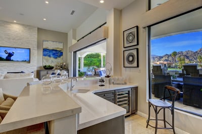 Wet bar with seating for 4 and wine refrigerator.