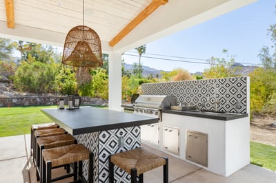 Full outdoor kitchen complete with BBQ, burner, sink and small fridge