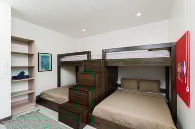 - Fun and functional bunk room with two twin over full wood beds and safe stairs
- Bright accent art
