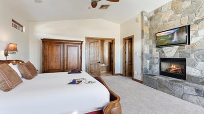 Primary suite with fireplace and TV