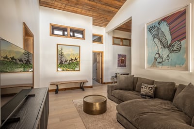 Unwind in this stunning living space with reclaimed wood ceiling, Native American art, and plush sec