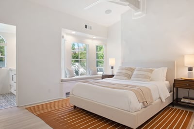 Suite 5: Queen bed and walk-in closet. This bedroom shares a Jack-n-Jill bathroom with Suite 6 featu