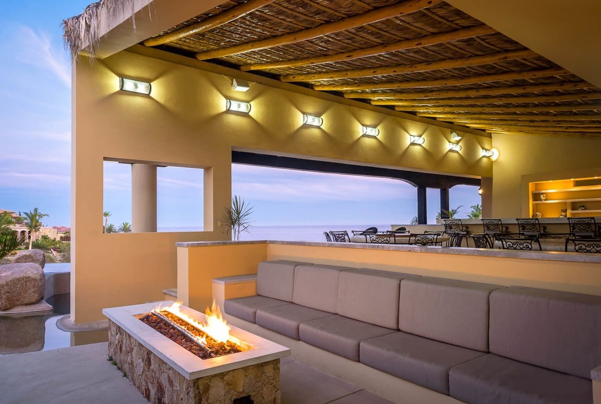 Gather around the modern, large firepit on plush cushions and seating at Casa Tita - Image 8