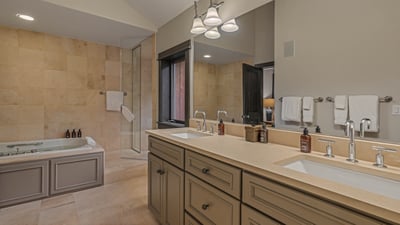 Queen ensuite on upper level with soaking tub, shower, and dual sinks