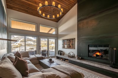 Sink into plush cushions by your crackling fireplace, where mountain views create the perfect backdr