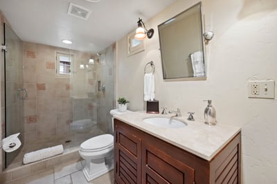 Your private bathroom features a spacious walk-in shower, polished vanity, and fresh towels—everythi