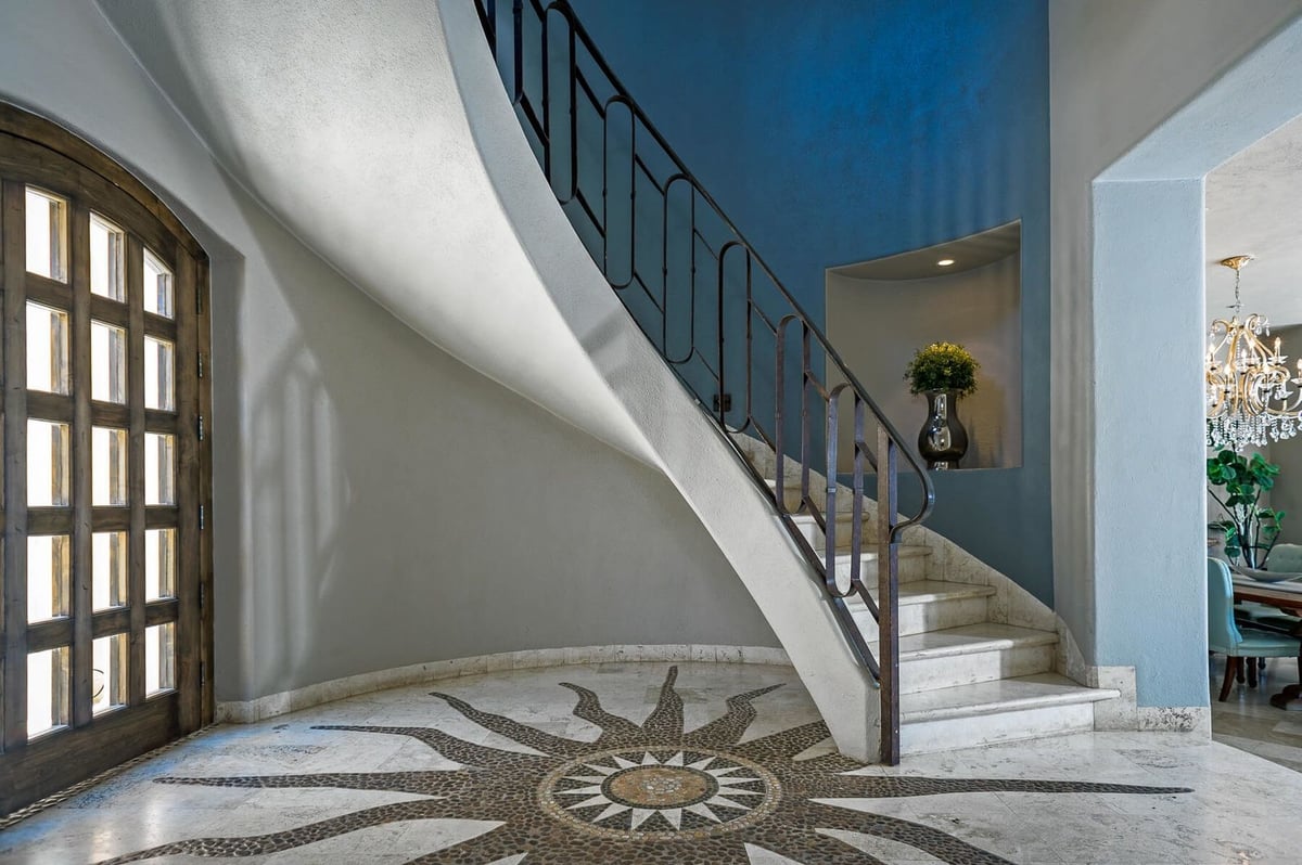 Enter into Casa Buena Vida and be met with an ornate floor design and a beautiful winding staircase - Image 12