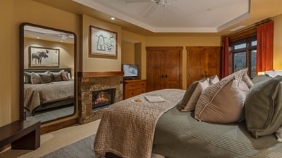 Primary king suite with fireplace and TV