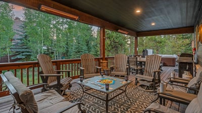 Covered back patio area with grill and seating