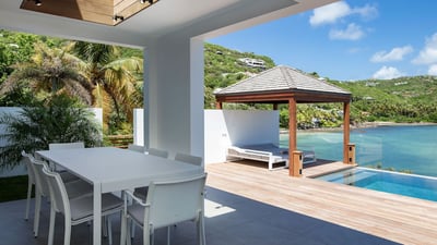 Outdoor Dining Area: Outdoor dining table on the covered terrace facing the view. 