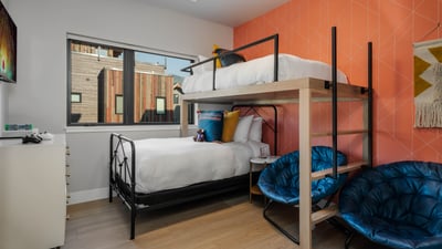 Twin-over-twin bunk bed, on the upper level sharing a jack-and-jill bathroom with the other bunk roo