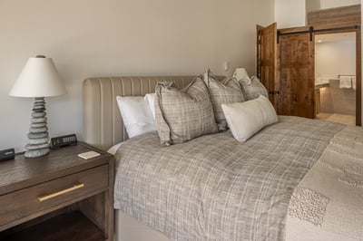 Sink into plush linens and rustic elegance in your serene bedroom retreat, complete with cozy textur
