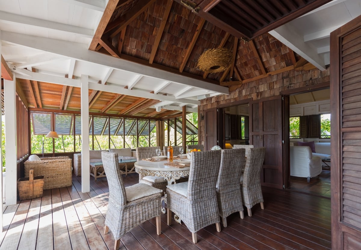 Dining Areas: Opened to the pool and terrace under a wood ceiling, large table and wicker chairs for - Image 8