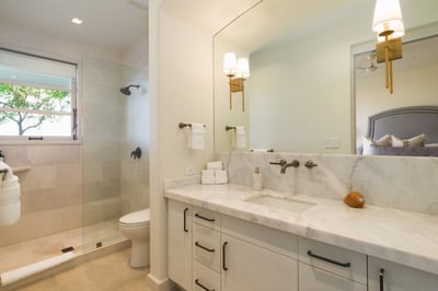 - Refresh in this light filled bathroom with soft tones and warm brass accents
- Marble vanity with 