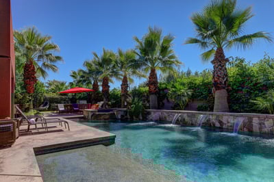 Large oasis pool with waterfall features for ultimate relaxation.