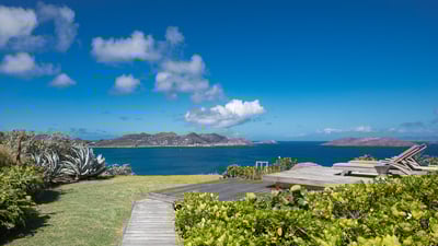 Outdoors: Beautiful lush garden surrounding the property. Private parking at the entrance of the vil