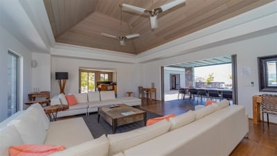 Living Area: Large leather sofas, ceiling fans. 