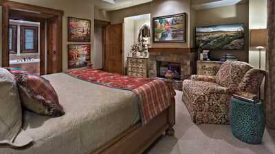 Primary suite with fireplace and TV