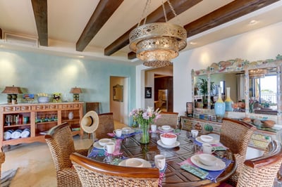 Dark wood beams along the ceiling add to the pastoral feel of this charming home.
