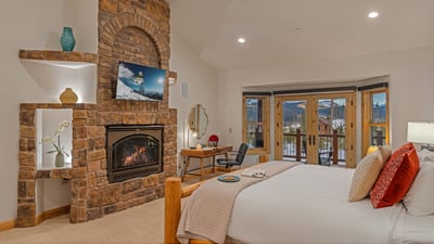 Bedroom 1, Lower Level - Gorgeous primary king suite on main level with TV, fireplace, and deck acce