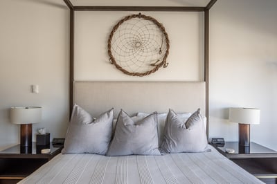 Sink into crisp linens and find peaceful rest beneath this stunning dreamcatcher, where modern comfo