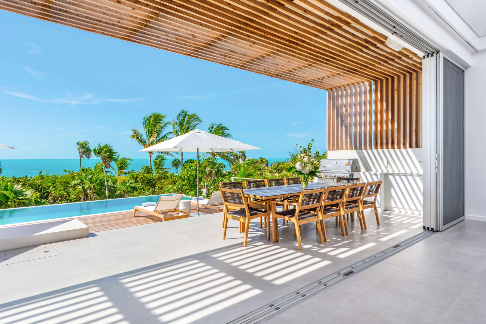 Villa deck and terrace wedding reception setup at Beach Enclave with ocean views and luxury outdoor dining