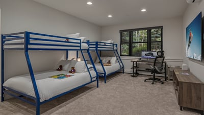 Bunkroom on lower level with office desk and chair