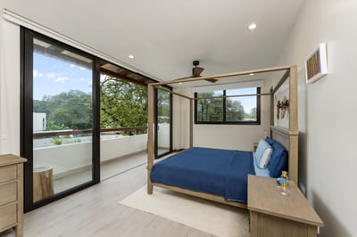- Wake up to serene tree views and step out onto your private balcony for fresh air
- Four post bed 