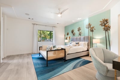 Primary bedroom with en suite bath, walk in closet and direct access to the patio