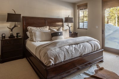 Sink into luxurious comfort with crisp linens and warm wood touches in your mountain retreat bedroom