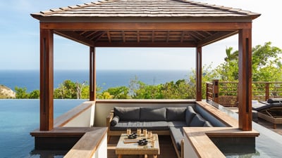 Gazebo: Next to the pool, facing the view, with lounge area. 