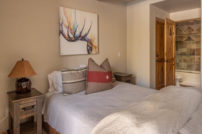Your cozy bedroom features rustic charm with beautiful artwork and an ensuite bathroom for ultimate 