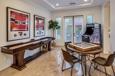 Fun game room with shuffle board, game table, arcade games, monopoly, chess and poker!