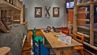 Bunkroom on upper level with 2 twin/twin bunk beds, two trundle beds, TV and game able