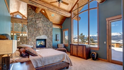 Primary suite on upper level with fireplace and views