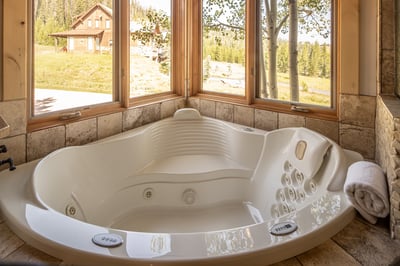 Unwind in your private hot tub with sweeping mountain views—soak away the day as you gaze out the wi