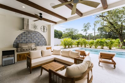 - Fire up the built in grill under breezy fans in this beautifully tiled poolside lounge
- Cushioned